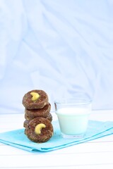 Chocolate cookies with cashew nuts. Served with glass of milk 