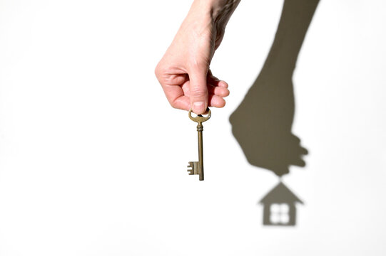 Real Estate Agent With House Key And House Swadow