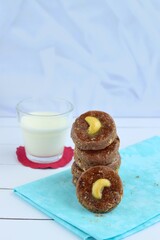 Chocolate cookies with cashew nuts. Served with glass of milk 
