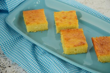 Traditional baked sweet coconut cassava cake. Cut in squares