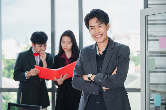 Group Of Confident And Smart LGBT Business People In Formal Attire Sit At Their Desks. There's A Laptop In The Background. Concept Of Relaxation. The Concept Of Diversity, Race And Culture.