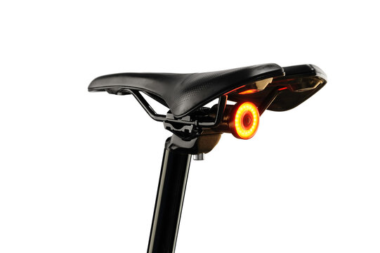 Close-up of illuminated bicycle tail light on background