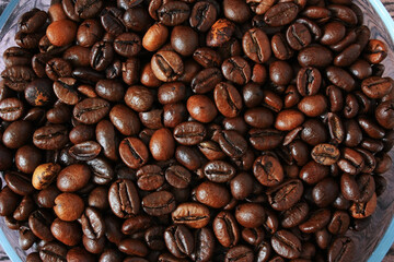 Fototapeta premium Brown coffee beans on a plate