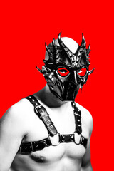 Creative artistic portrait of a rubber fetish, latex young man with fashion mask and leather harness on a red background. - obrazy, fototapety, plakaty