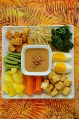 Traditional Indonesian Food, Gado-gado. Made from egg, tempeh, fried tofu and boiled vegetables like; yard long beans, carrot, bean sprouts, potato, spinach, served with peanut sauce