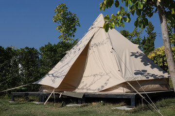 The white tent is camping in the garden at morning