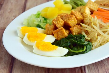 Traditional Indonesian Food, Gado-gado. Made from boiled vegetable, bean sprouts, egg, tempeh and fried tofu served with peanut sauce