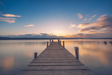 Obraz na płótnie Canvas Old wooden dock at the lake, sunset shot