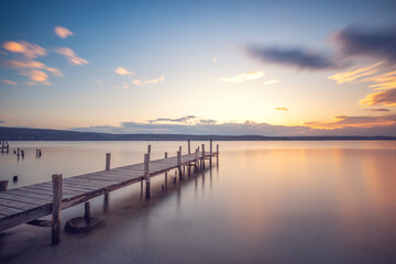 Naklejka na ściany i meble Old wooden dock at the lake, sunset shot