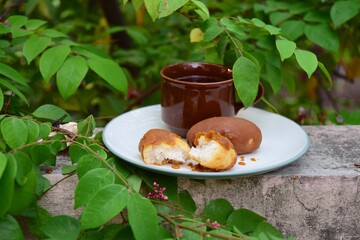 gemblong or coconut cake, glutinous rice flour balls smeared with palm sugar caramel. Indonesian traditional food. 
