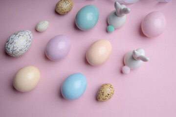 Easter colorful photografie with eggs group and bunny egg  on pink background, copy space 