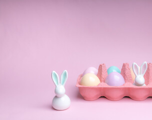 Easter colorful photografie with eggs group and bunny egg  on pink background, copy space 