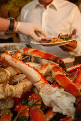 Bowl of gourmet fresh seafood on ice with savory sauce serve with white wine glass on vintage wooden table. Restaurant gastronomy food and drink consumerism concept. High quality photo