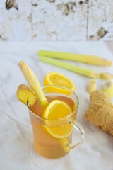 Ginger lemongrass tea hot drink with lemon on white background