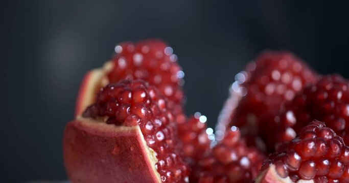 Pomegranate fruit. Fresh and ripe Pomegranates rotating over black Background. Organic Bio fruits close-up. Diet, dieting concept. Vegan food. 4096 2160 video.