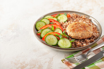 Delicious home lunch - buckwheat with chicken cutlets and vegetables. Top View