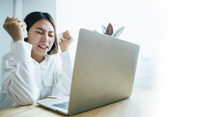 Beautiful asian call center staff talking and provide services to customers via headphones and microphone cable with surrounding paper. Concept of controlling emotions and suppressing anger
