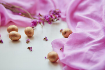 Easter poster and banner template with Easter eggs on light pink background. Greetings and presents for Easter Day in flat lay styling. Delicate pink banner