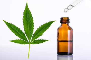 Marijuana or Cannabis green leaf. Essential oil for aromatherapy. Brown glass bottle with medicine dropper or pipette. Medical marijuana sativa or indica. Organic cannabis oils. US Decriminalize weed.