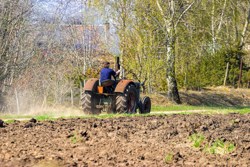 Old tractor driving on a road