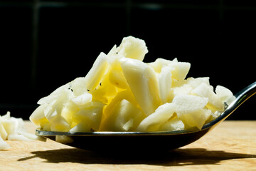 chop garlic on wood plat with lighting on top.