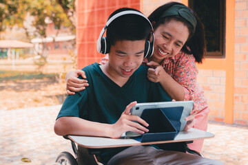 Special need child on wheelchair use a tablet in the house with his parent, Study or Work at home...