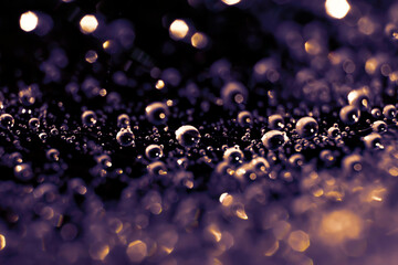 Violet colored toned backdrop made of spiderweb with plenty water drops on web ornamental threads