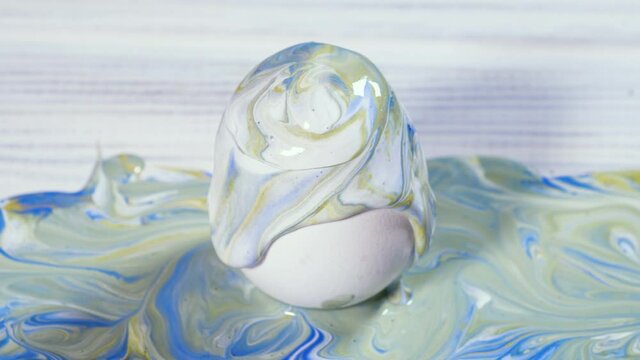 Painting Easter eggs, Preparation for spring holiday, Liquid marble texture, Marble ink colorful, Fluid art Abstract Trend