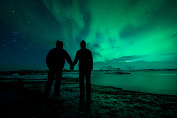 a couple looking at the northern lights