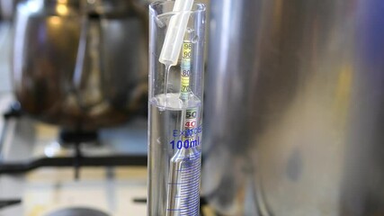 Measuring the degrees of moonshine with an alcohol meter. Production of strong vodka at home.