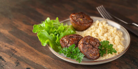Healthy lunch - chicken liver maffins with salad and couscous on the table