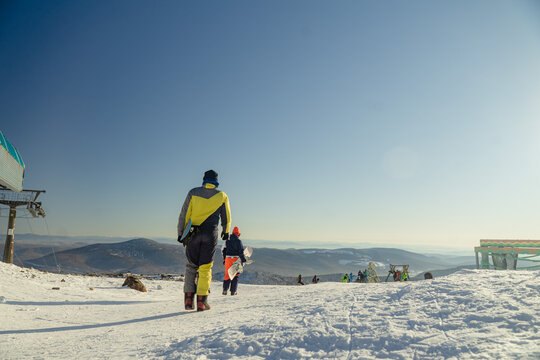 friends go for a ride with a snowboard in their hands, sheregesh February 15, 2021