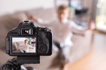 Vlogger recording social media video while sitting on the couch