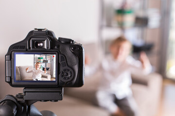 Vlogger recording social media video while sitting on the couch