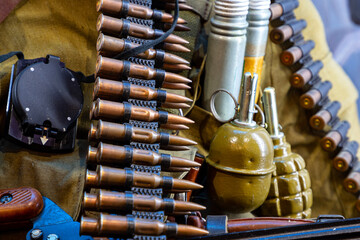 Machine-gun belt with equipment on a soldier during the war. Military action in the world.