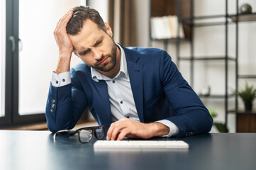 Mature exhausted businessman thinking about budget and future of his company, overworked, bankrupt,...