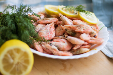 Fresh tasty shrimps with lemon on a plate
