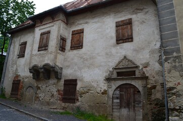 facade of an old house with a oriel window  wooden shutters and door and a decorative arch, Banská Štiavnica