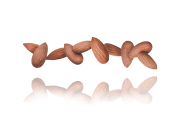 Whole Almonds nuts in a row isolated on a white Background floats in the air. Food Levitation...