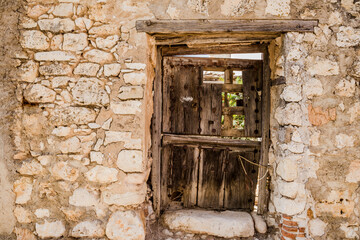 Ruin house wall window texture retro background. A dirty ancient urban abandoned home with broken wooden windows 