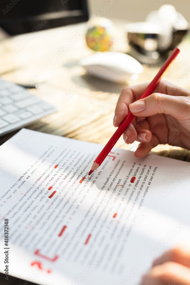 Poster person marking error with red marker