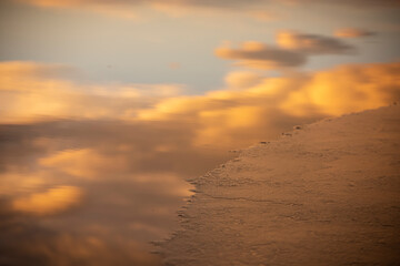 Clouds reflected on water and ice