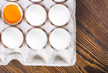 Chicken egg is half broken among other eggs