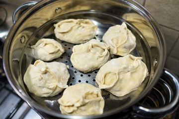 Manty in a double boiler. Steamed dish of dough and meat.