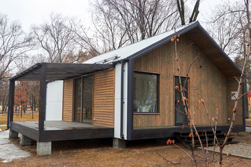 Almaty, Kazakhstan - February 20.2021: sample of a modular house with a terrace installed in a public park