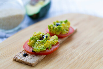 Healthy snack. Snack with avocado and tomato. Bruschetta with tomatoes, avocado and radish.