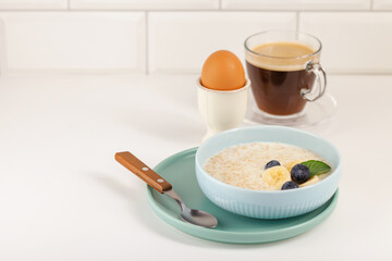 Healthy breakfast - oatmeal with berries  in a bowl on the table.