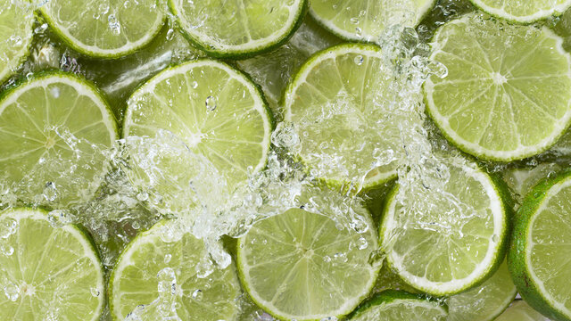 Top view of sliced lime with water splashes