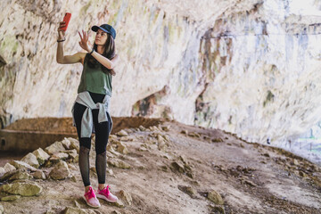 Girl taking selfie in font of devetashka cave near lovech