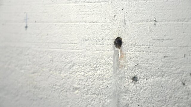 water flowing out of a wall in a house